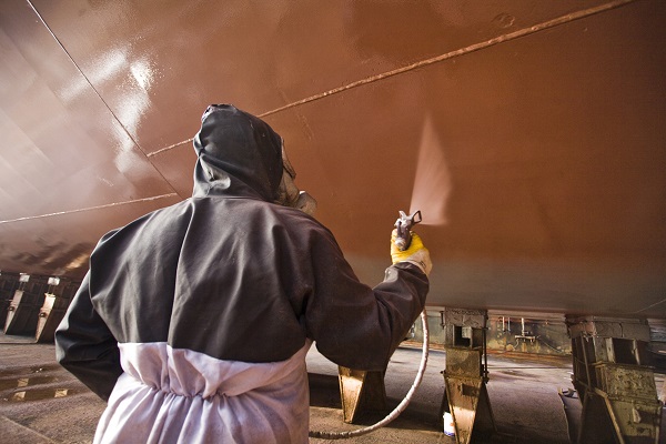 Ship painting in shipyard with spray